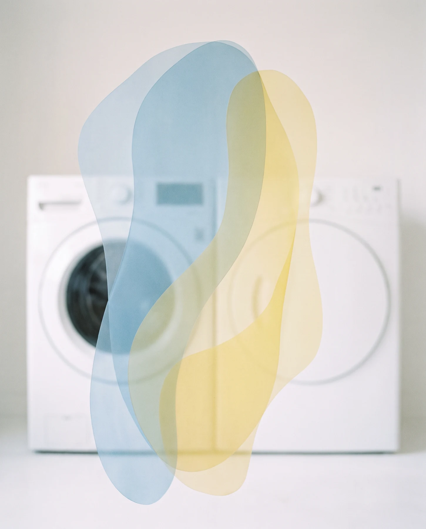 A front-loading appliance with abstract translucent colored shapes